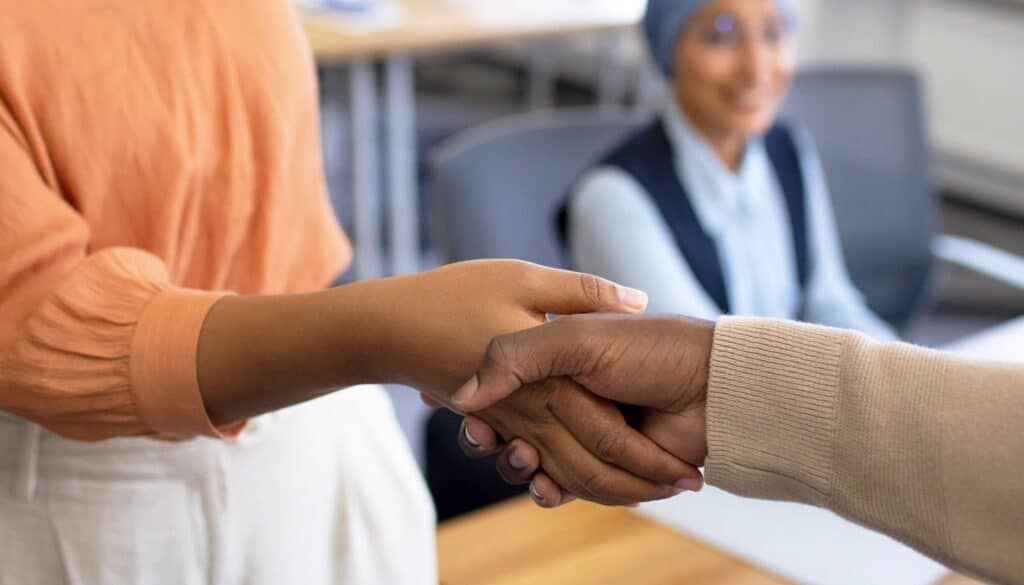 Female teachers shaking hands