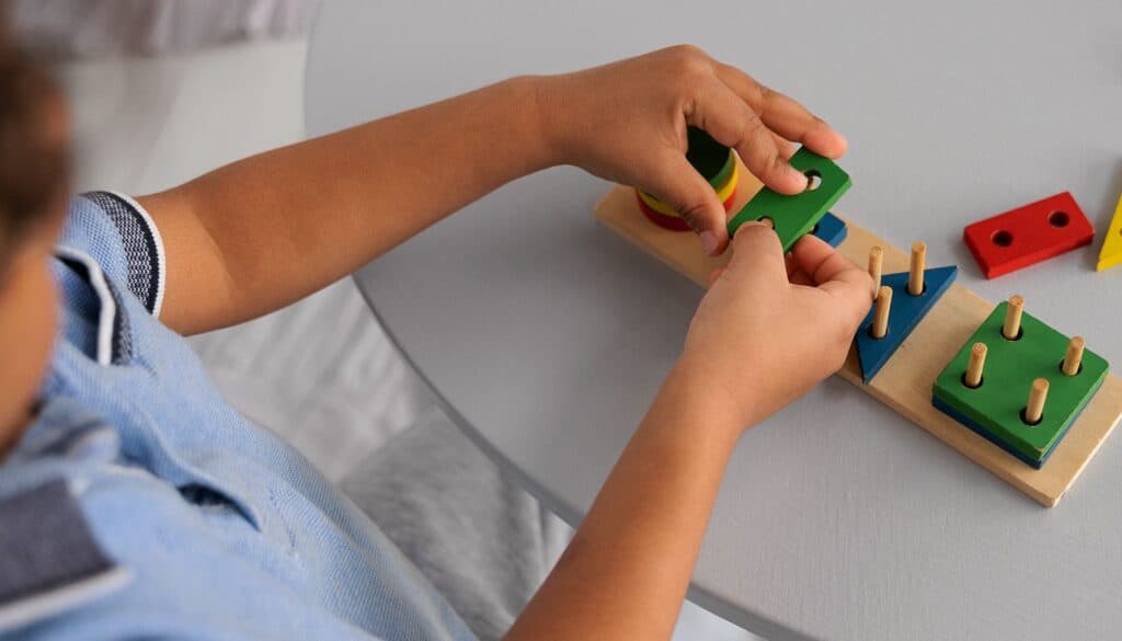Child playing didactic shapes game