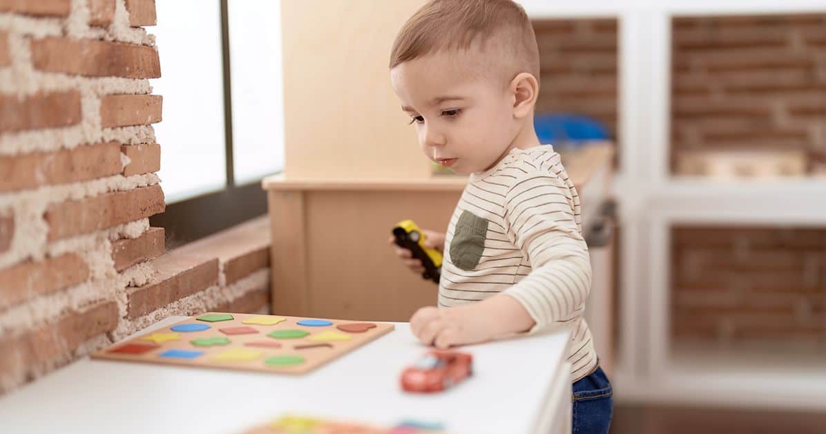 Toddler playing with cars
